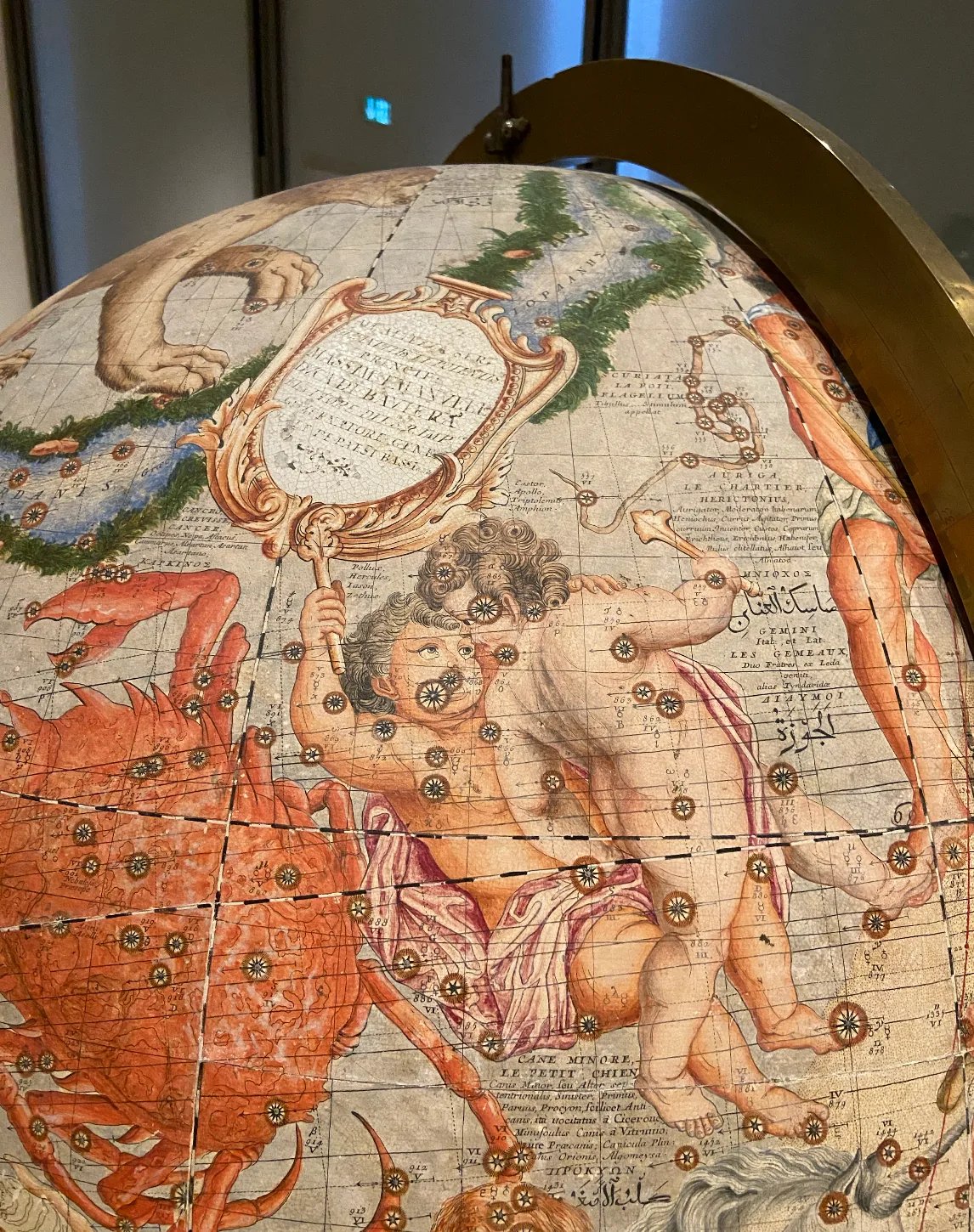A detail of the constellation figures drawn across a celestial globe