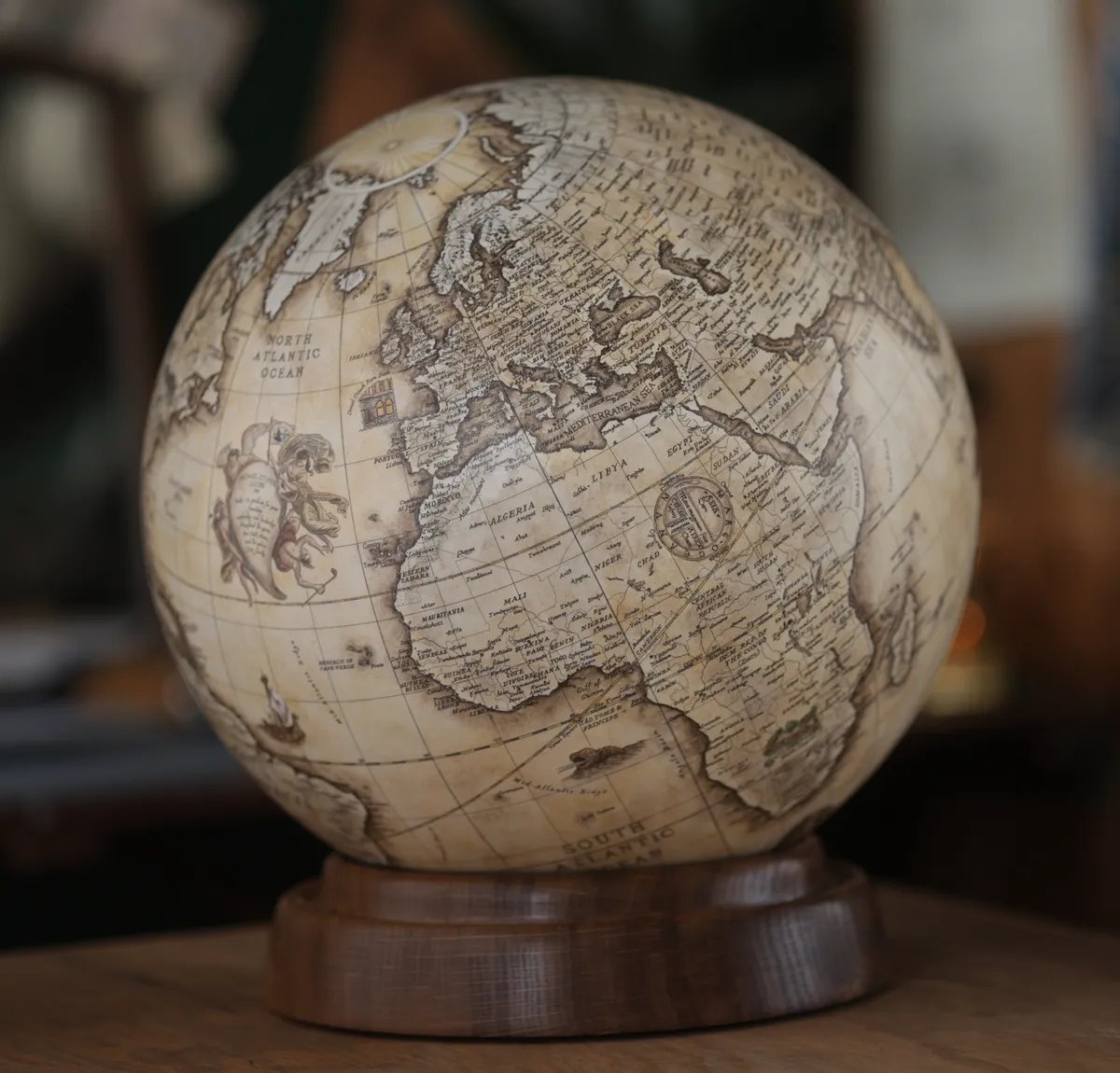 A terrestrial globe on its turned oak base