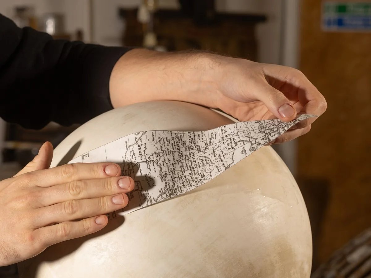 Applying hand-printed paper to a globe gore